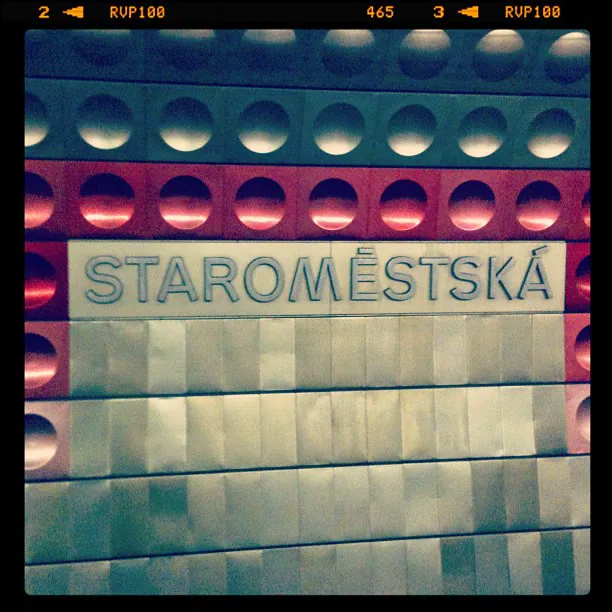 Prague metro sign for Staroměstská on a wall of round, dimpled metal panels