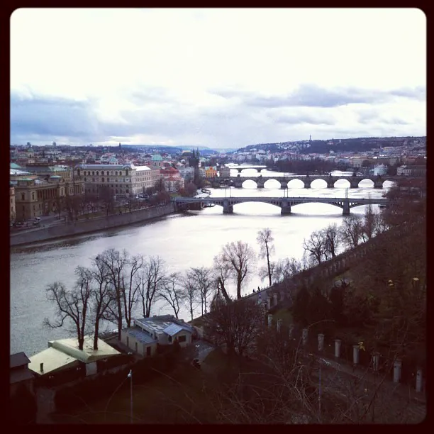 Prague from above, with its bridges crossing the Vltava under a grey sky