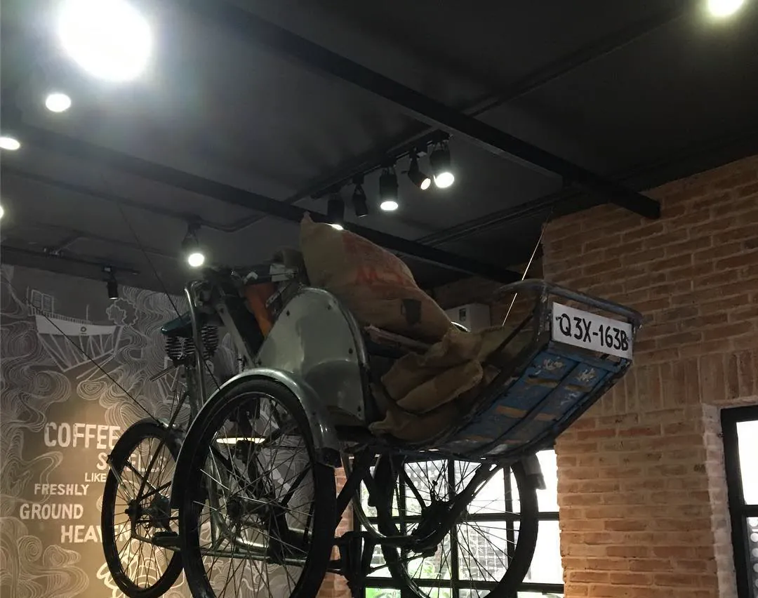 An old cyclo hanging above the counter of a coffee shop in Saigon