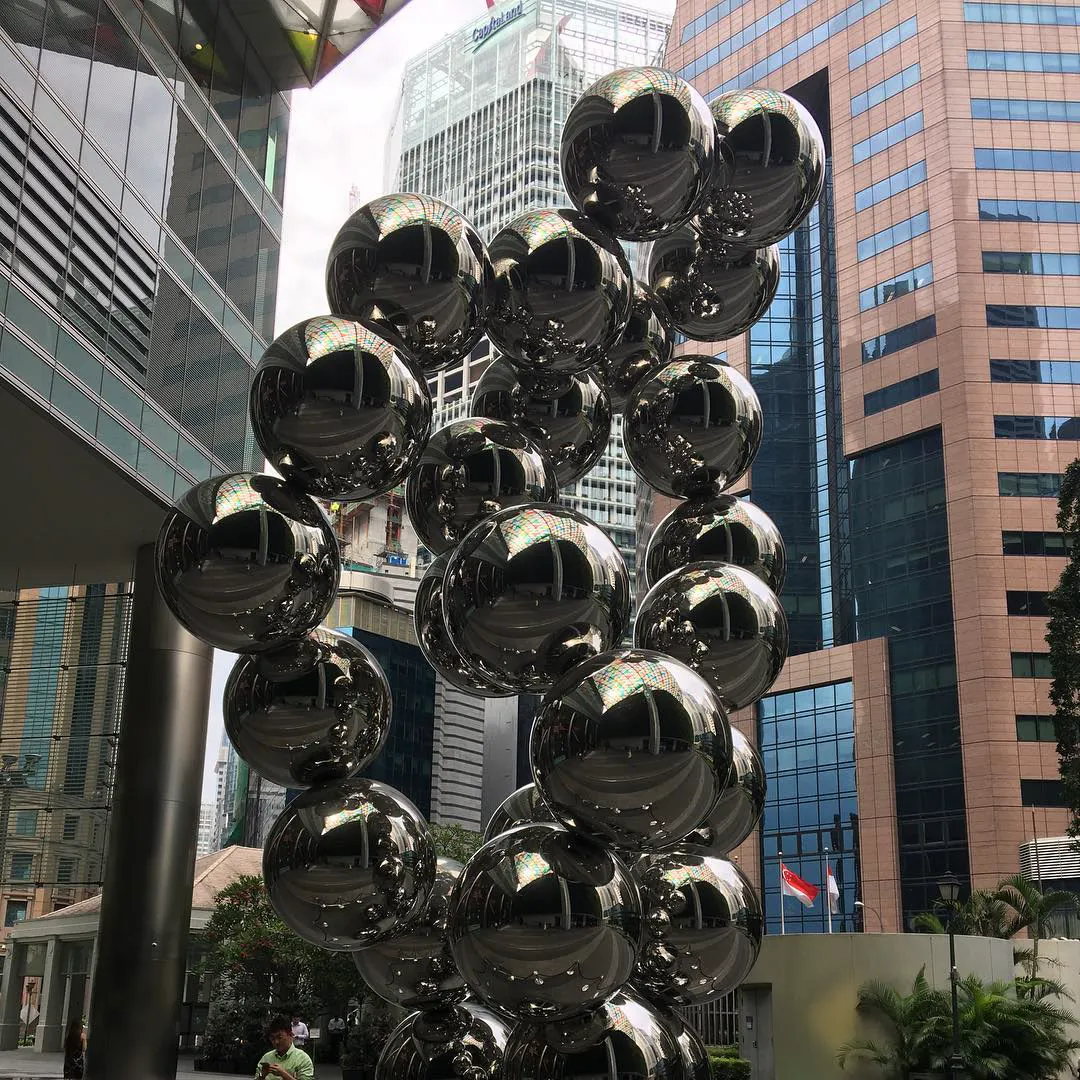A sculpture of shiny steel balls among Singapore's office towers