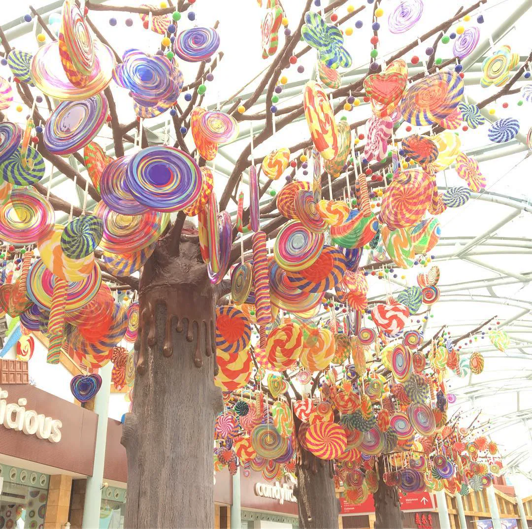 Trees hung with giant lollipops and swirls of candy on Sentosa island