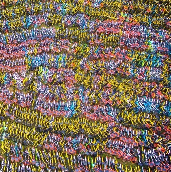 Thousands of shared bikes in a sea of yellow, blue and pink, in China